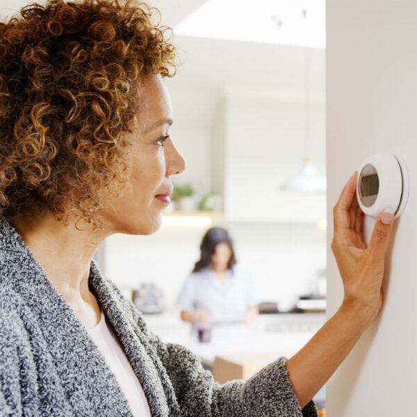 Woman-Checks-Thermostat-600x600-1