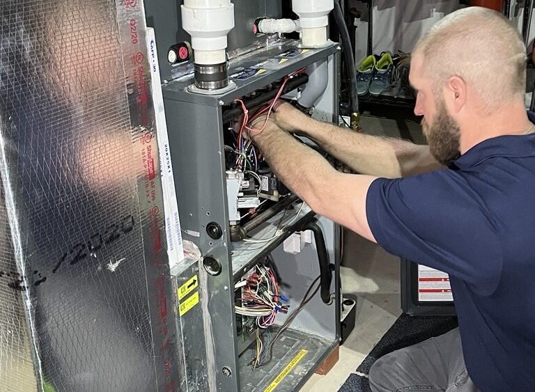 hvac technician working on a system