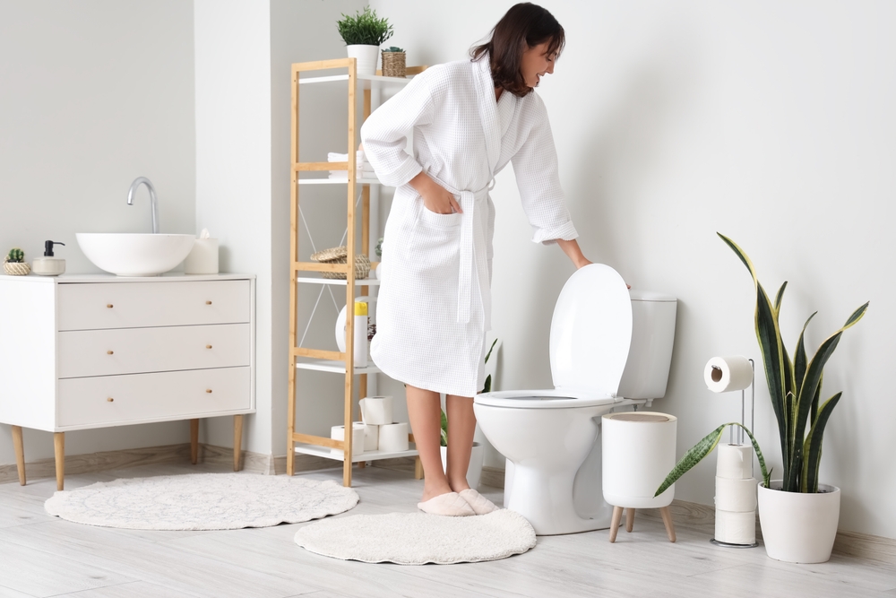 woman flushing the toilet